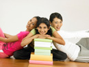 women looking at the camera with stack of book